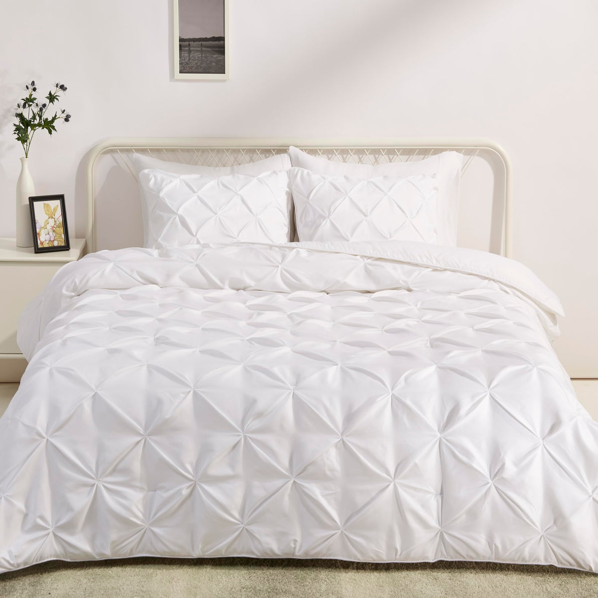 Amazon Basics pinch-pleat king comforter in bright white for a clean bedroom look.