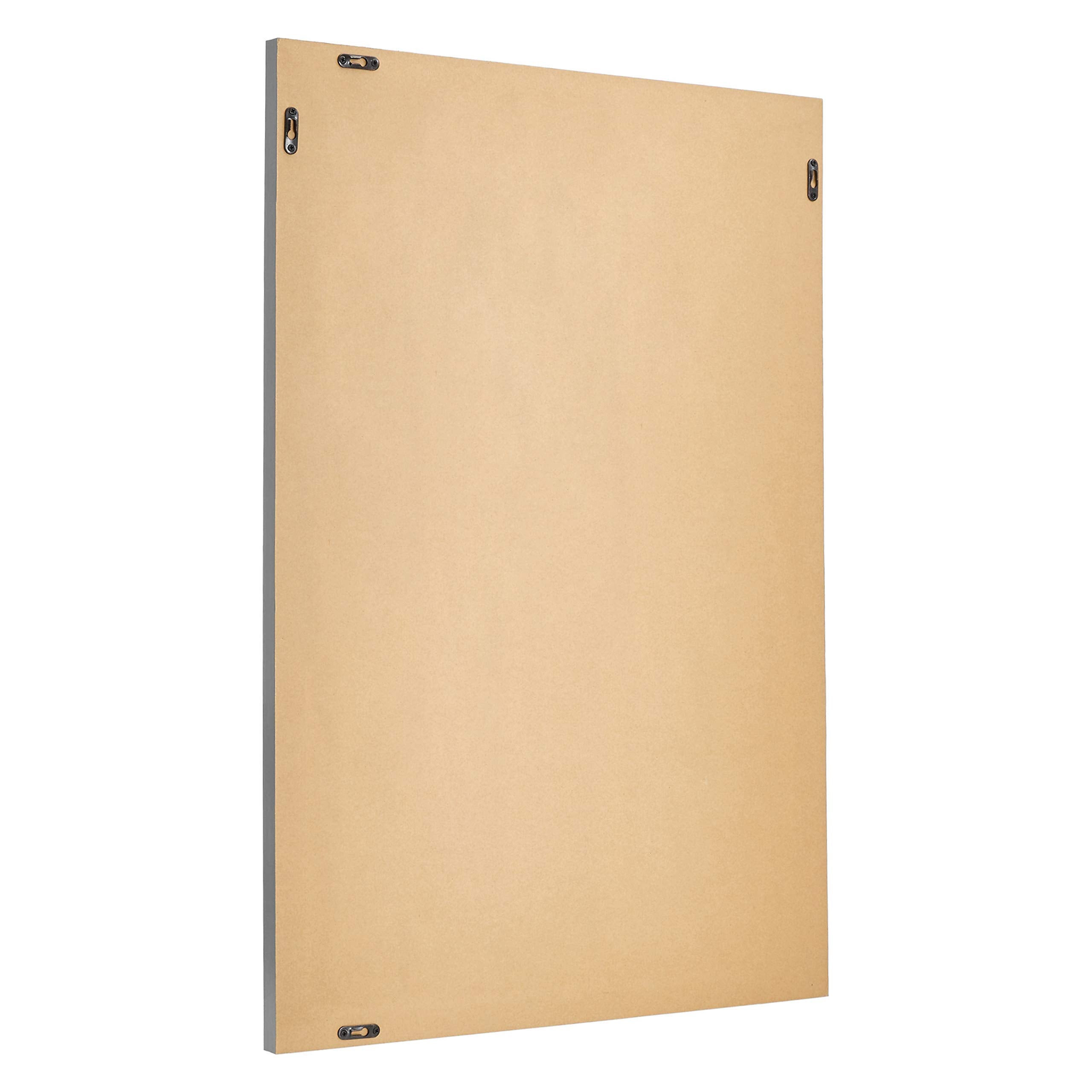 Amazon Basics rectangular wall mirror 24x36 hanging vertically ideal for hallways and bedrooms.
