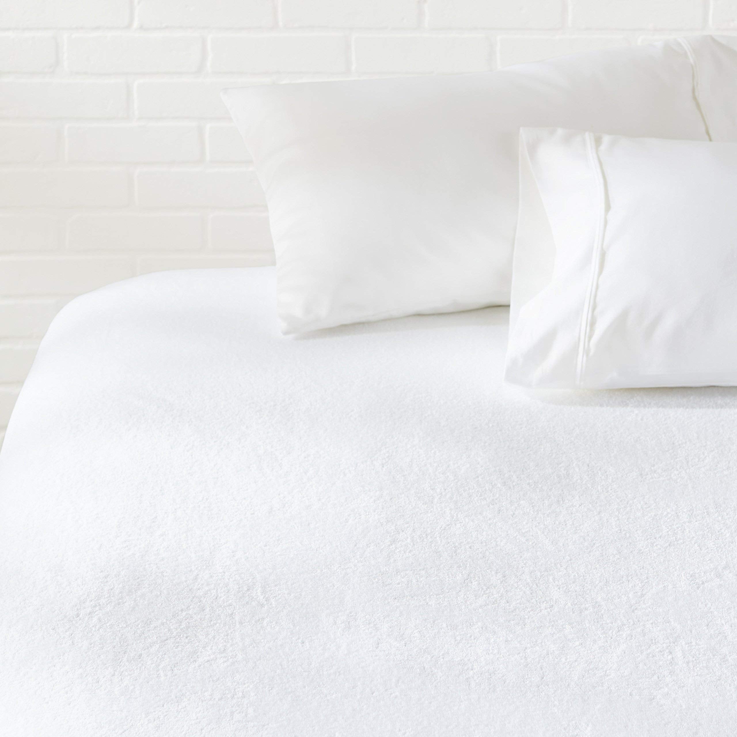 Amazon Basics waterproof mattress protector for king beds blocks spills while staying breathable.