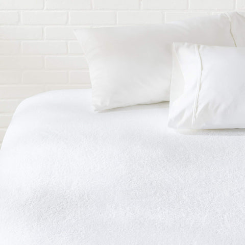 Amazon Basics waterproof mattress protector for king beds blocks spills while staying breathable.