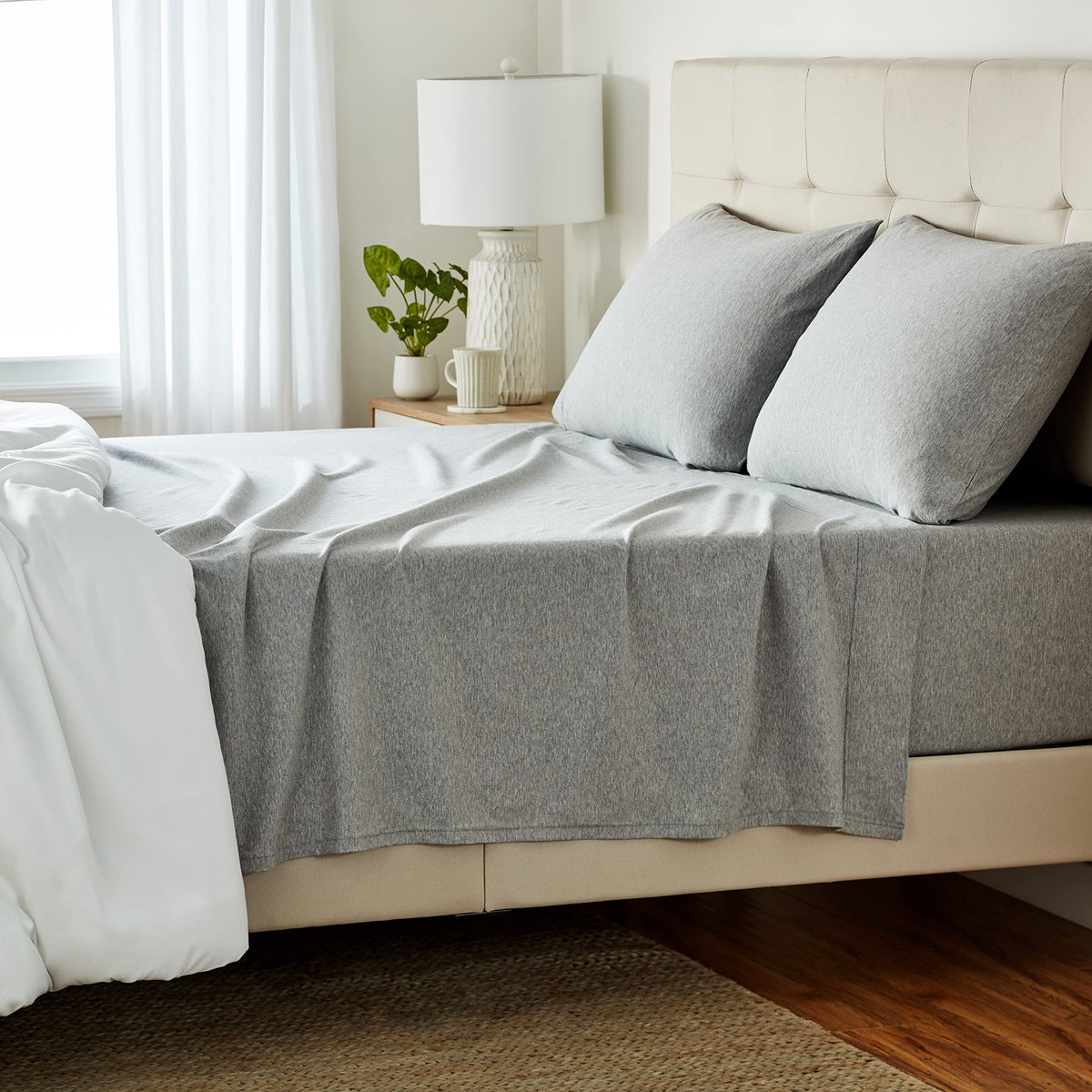 Amazon Basics 4-piece sheet set in light gray, front view shows breathable cotton jersey.