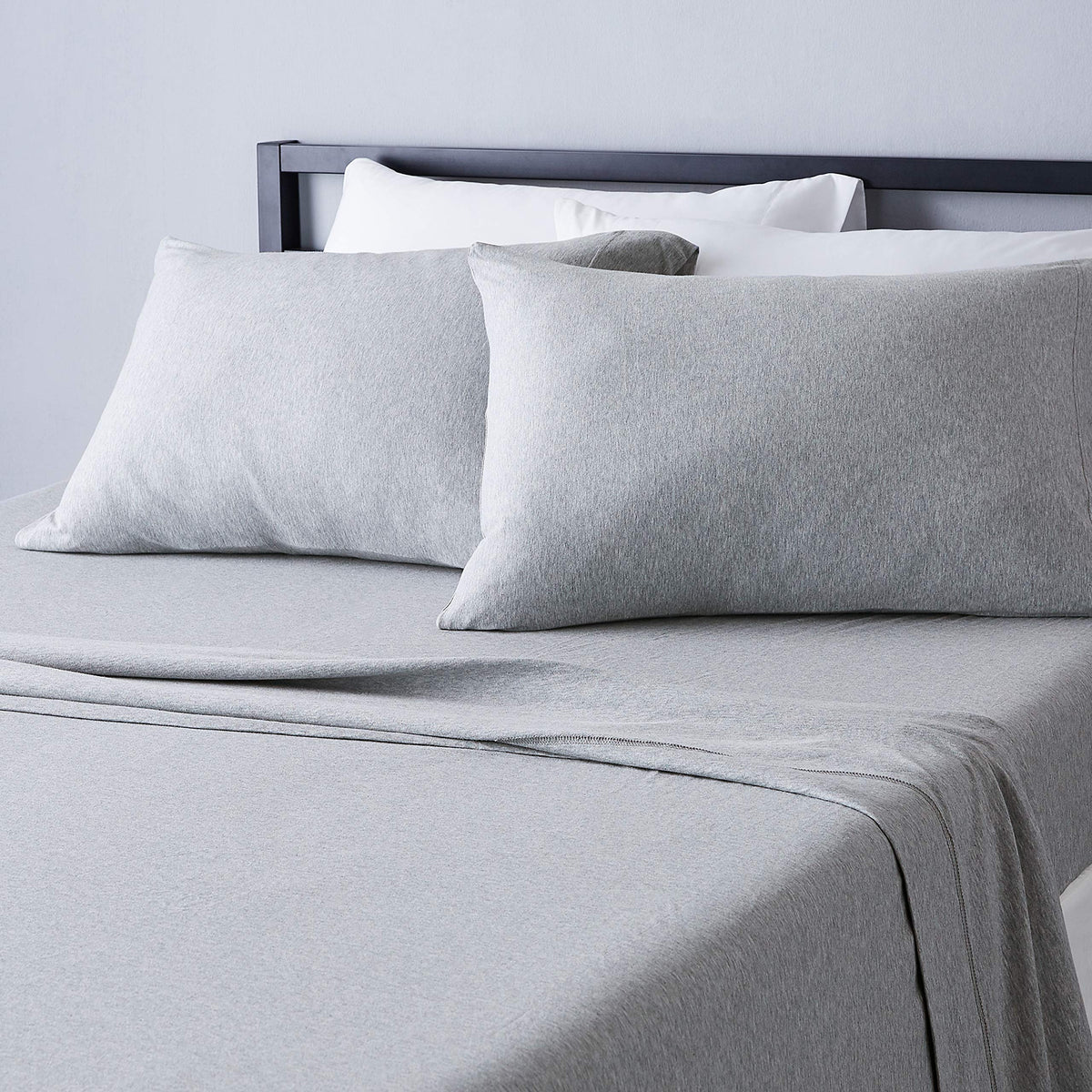 Amazon Basics cotton jersey king sheet close-up shows soft, breathable fabric.