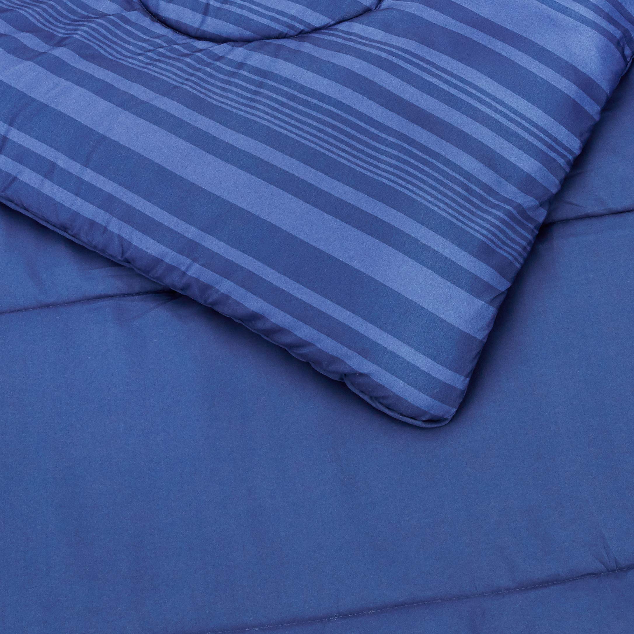 Amazon Basics blue Calvin-striped sham complements the bed ensemble