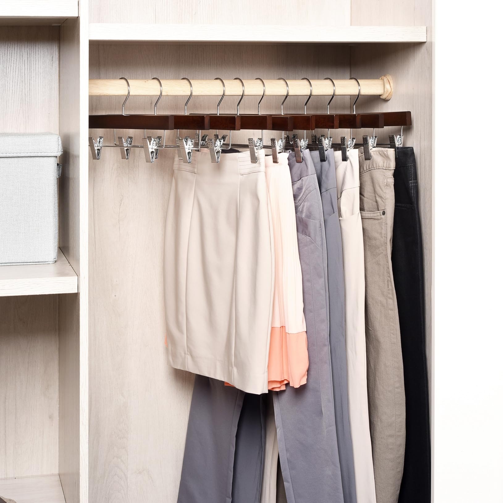 Amber Home 14-inch wood hangers support long garments with secure clips.