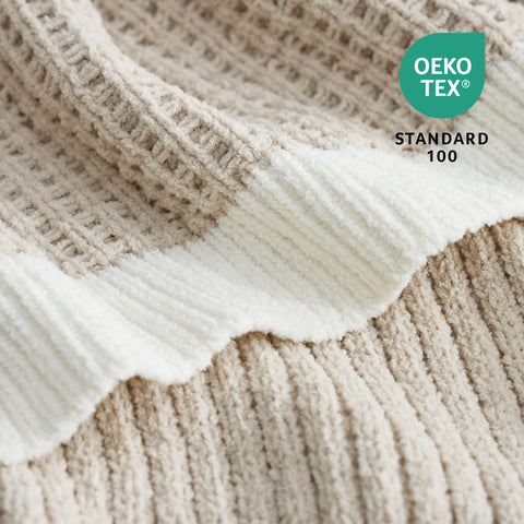Amélie Home chenille throw beige draped over sofa for stylish warmth.