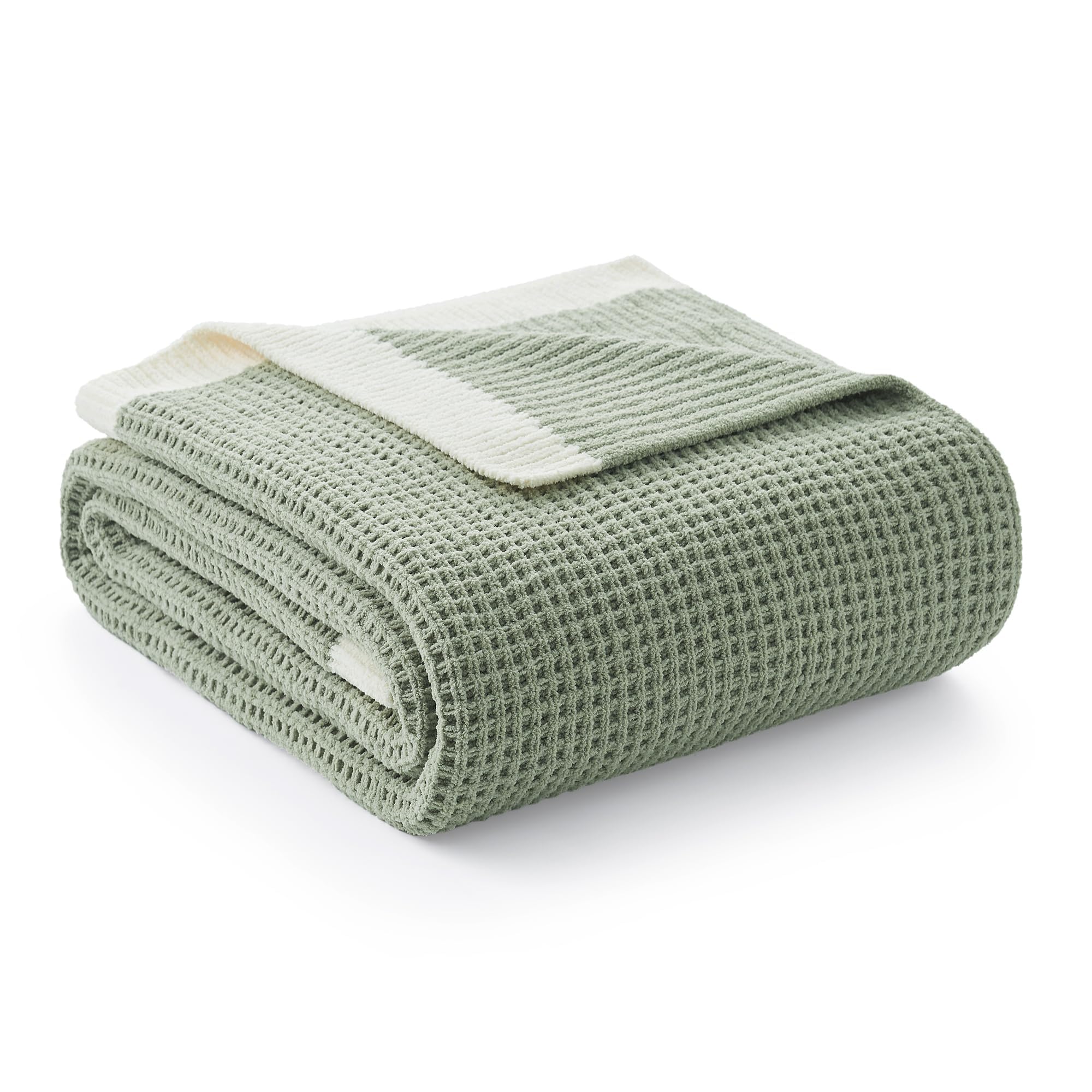 Amélie Home chenille waffle throw with soft touch draped over a sofa for cozy comfort.