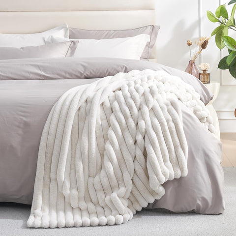 Amélie Home blanket on couch showcasing plush comfort for family time.