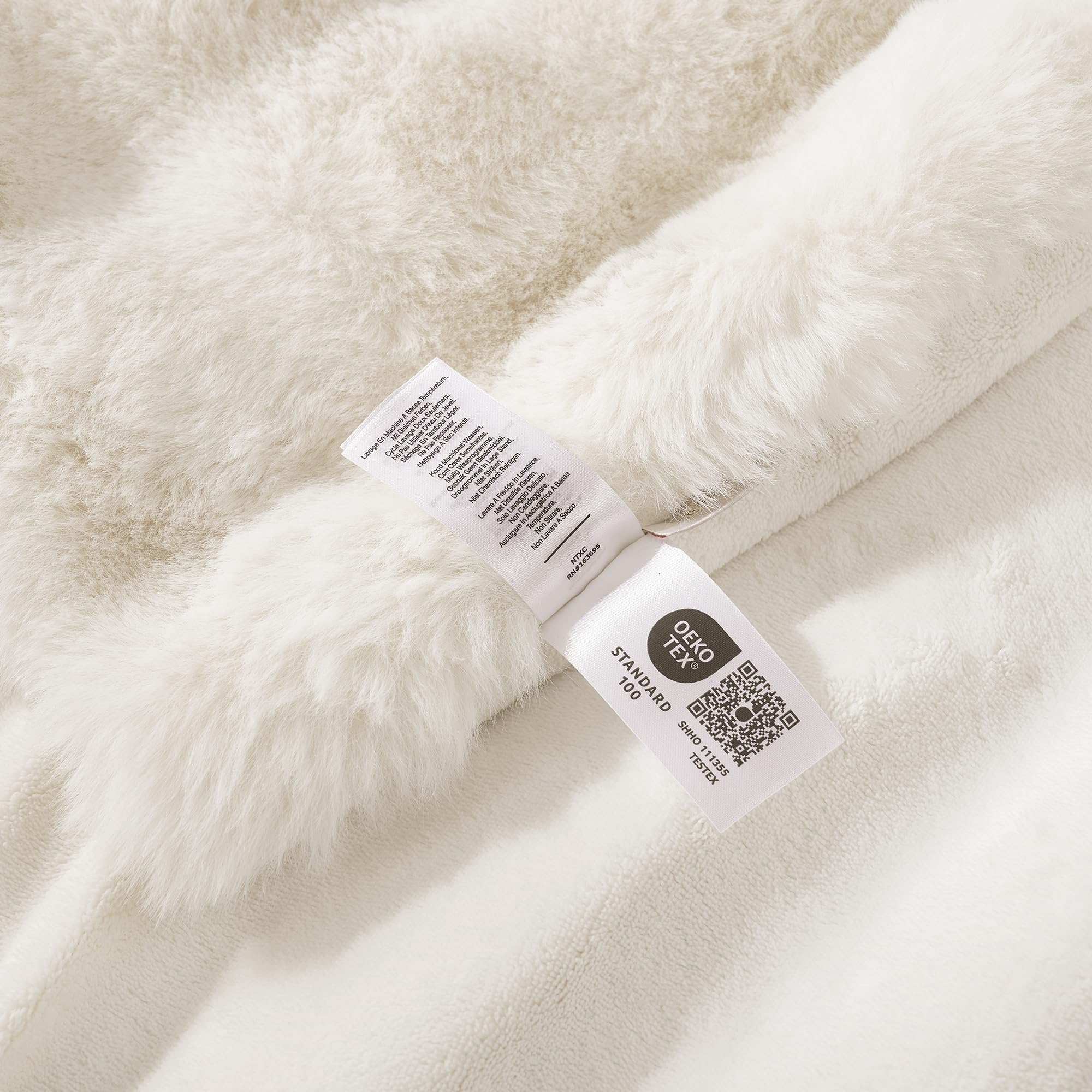 Amélie Home cream faux fur throw complements living room decor