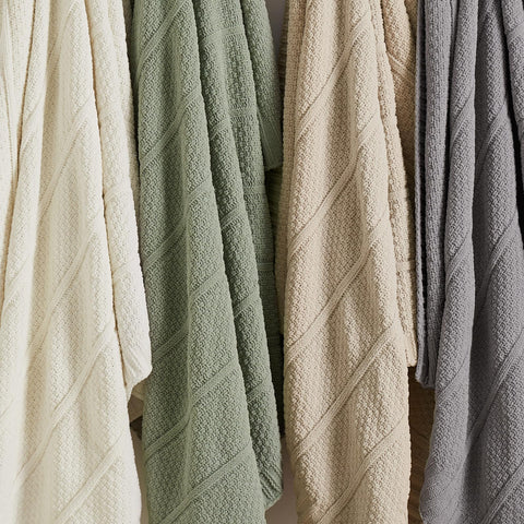 Amélie Home cream-white throw complements neutral decor schemes.