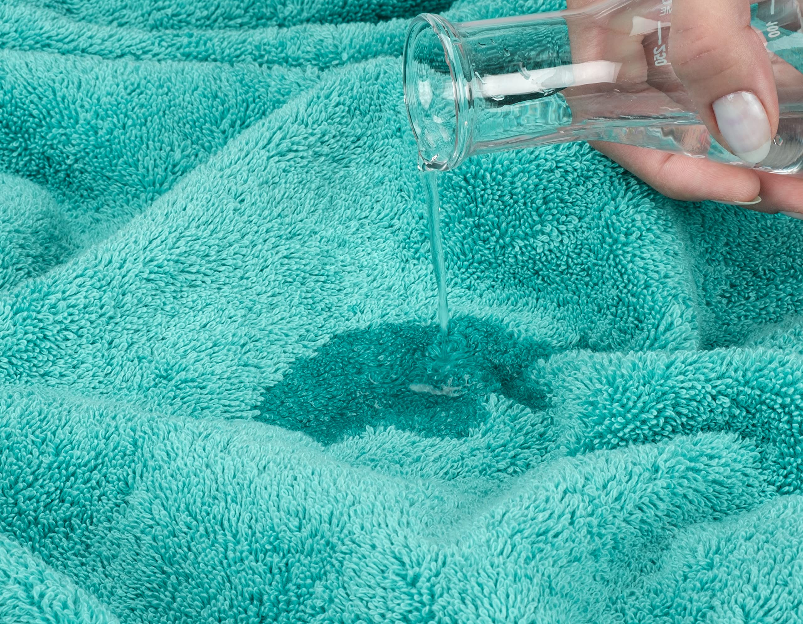 Turquoise towels in a spa-like bathroom setting demonstrating absorbent comfort.