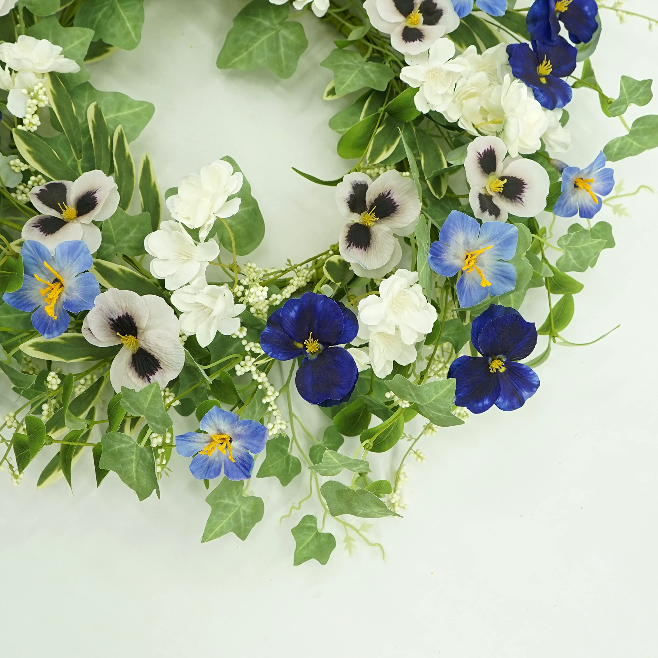 AMF0RESJ wreath hanging on a door, ready to welcome guests indoors or under cover outdoors.
