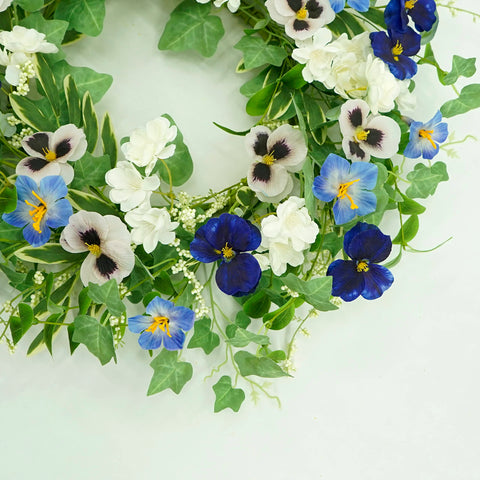 AMF0RESJ wreath hanging on a door, ready to welcome guests indoors or under cover outdoors.