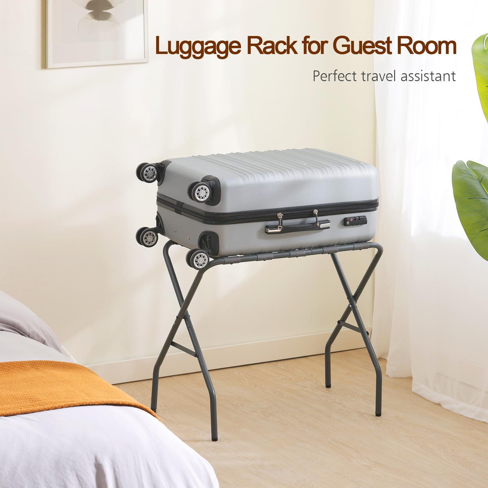 AMHANCIBLE luggage rack in action beside a suitcase in a hotel setup