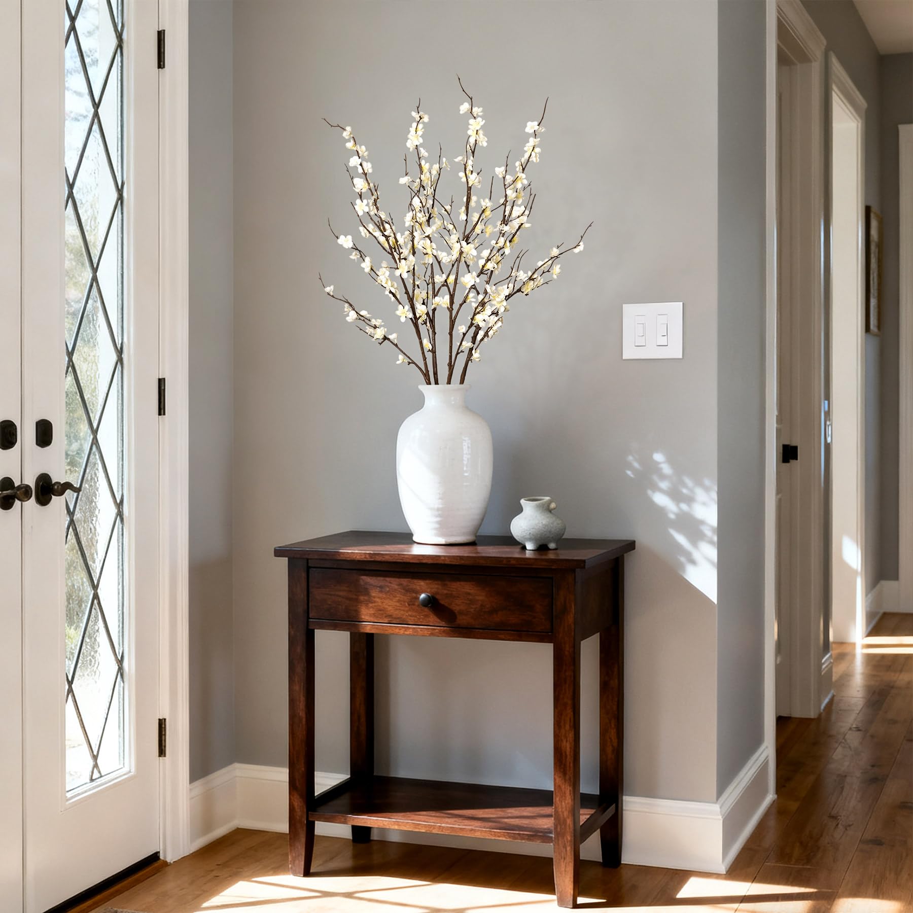 Ammyoo branch arranged in a tall vase for elegant display.