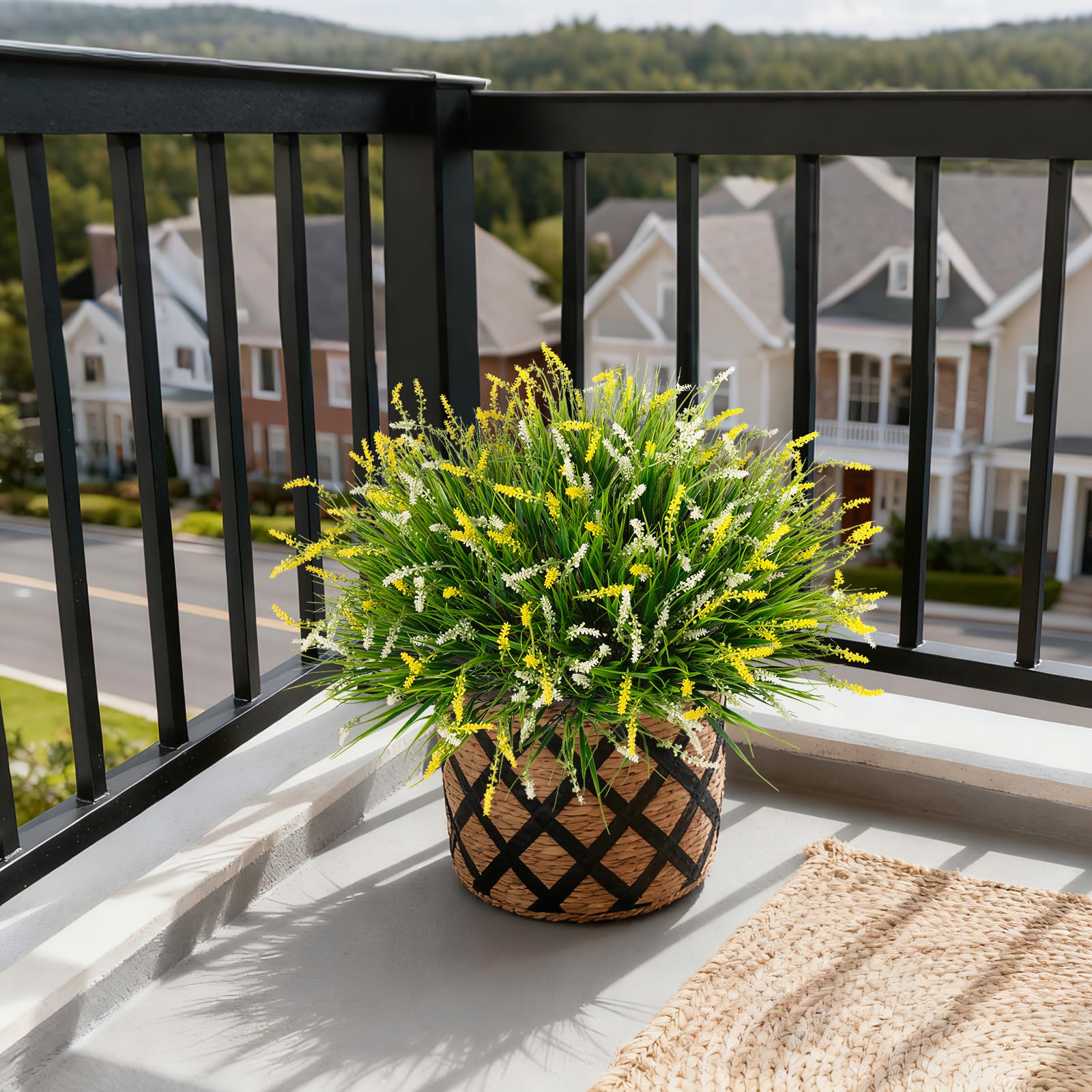 Ammyoo outdoor faux monkey grass on porch railing creates vibrant, maintenance-free greenery.