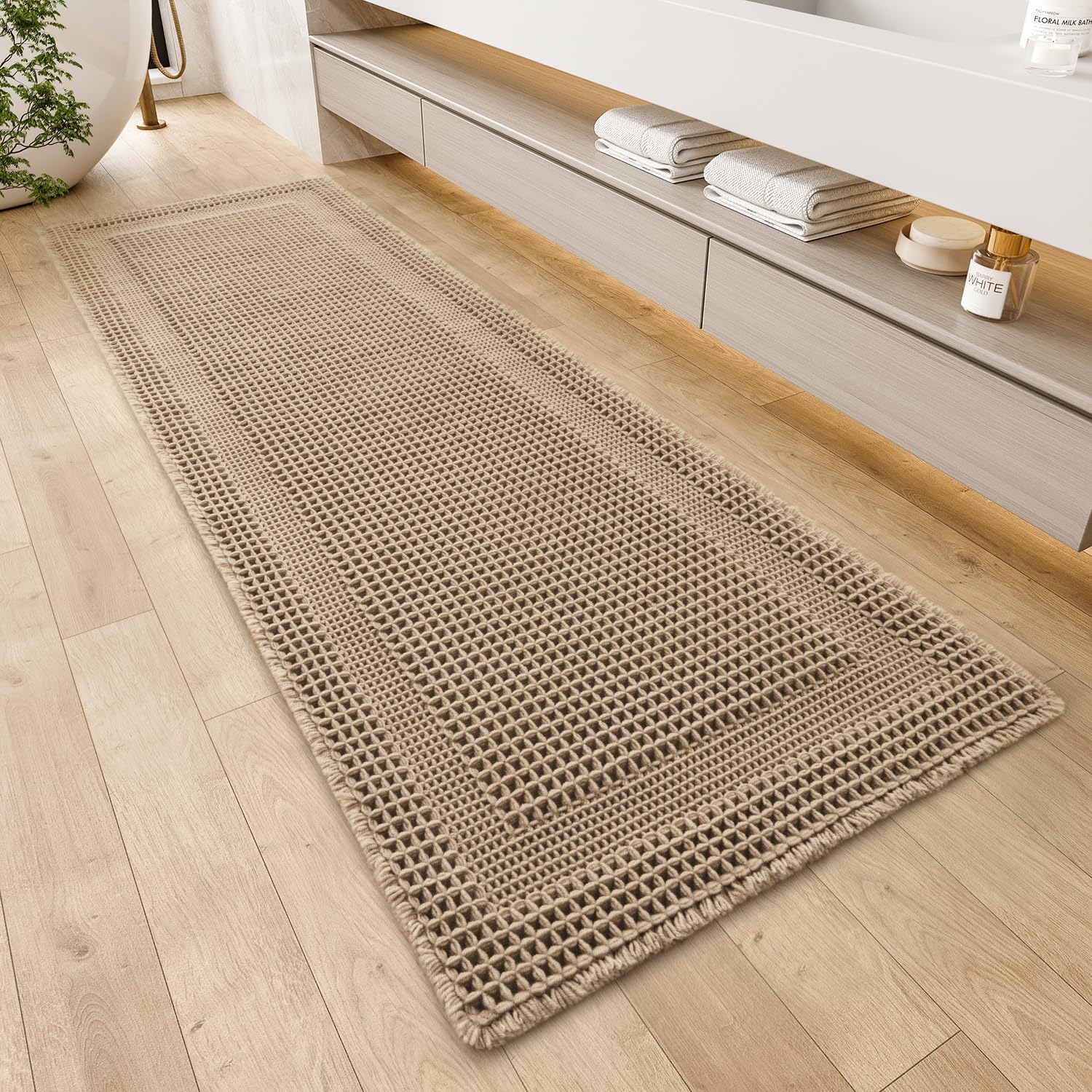 AMOAMI waffle bath mat in beige with absorbent texture for dry bathroom floors.