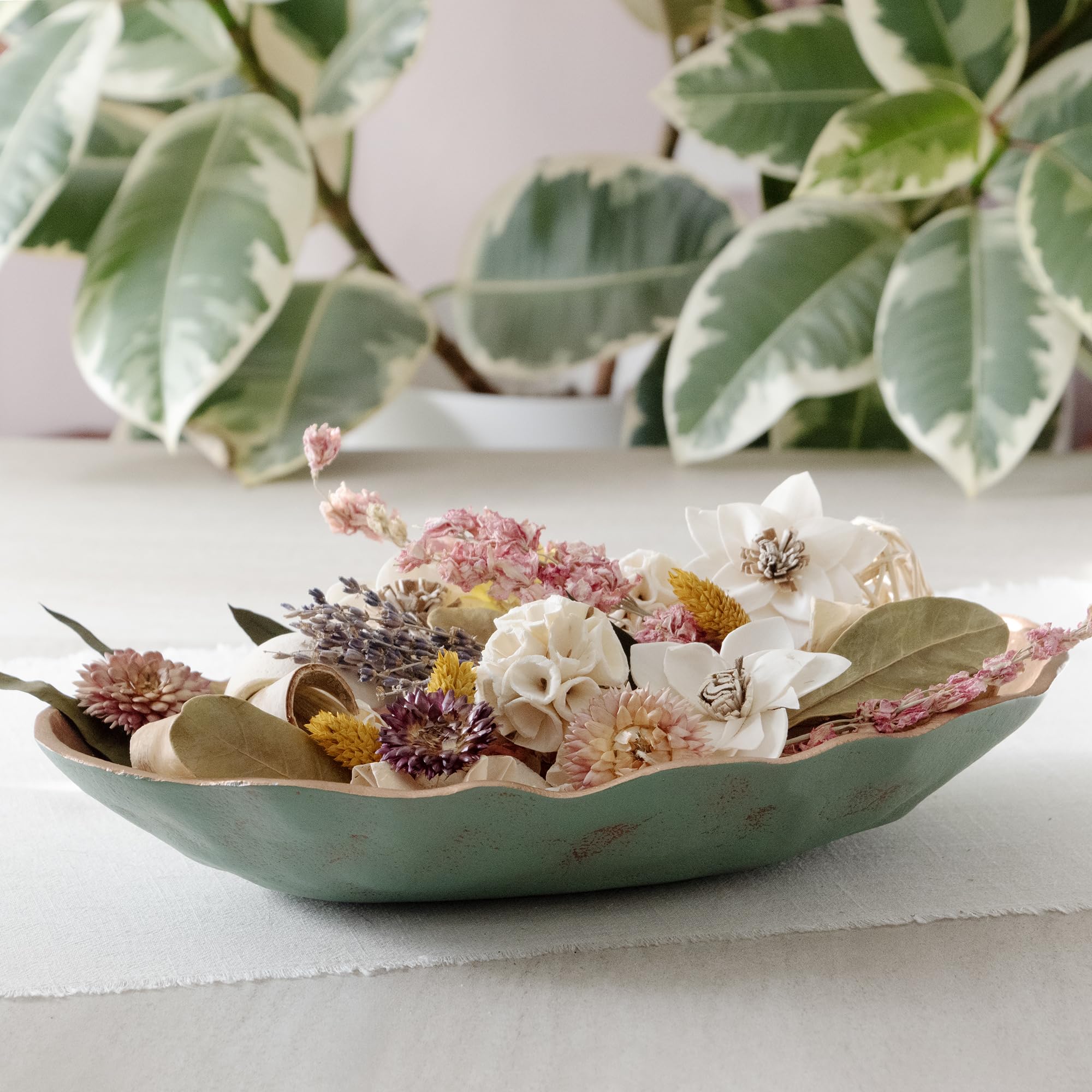 ANDALUCA potpourri poured into wood bowl for an elegant table accent.