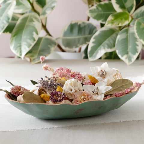 ANDALUCA potpourri poured into wood bowl for an elegant table accent.