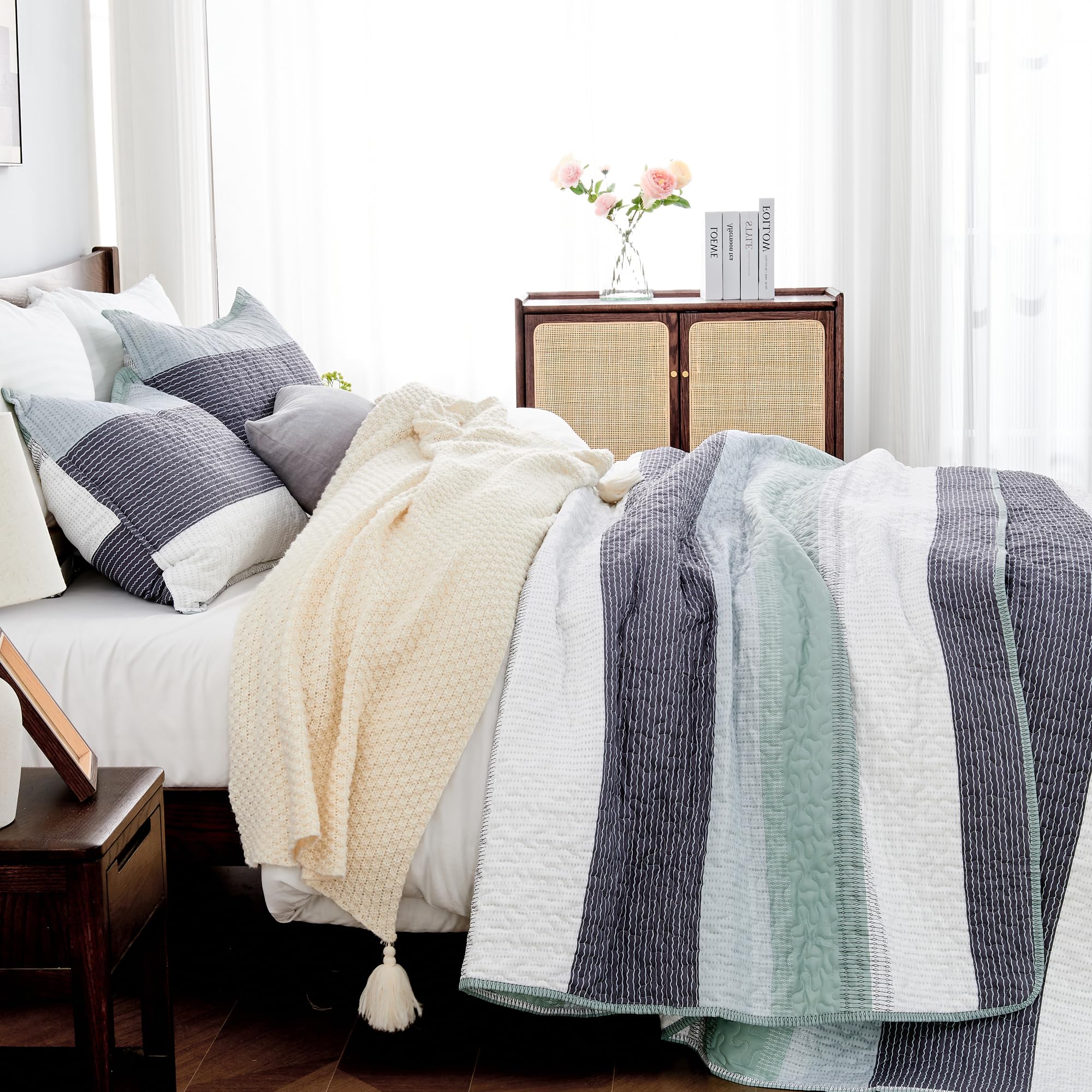 Andency striped quilt with mint and gray patchwork pillow shams enhances contemporary decor.