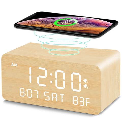 Andoolex wooden digital alarm clock with wireless charging on a nightstand, clutter-free charging.