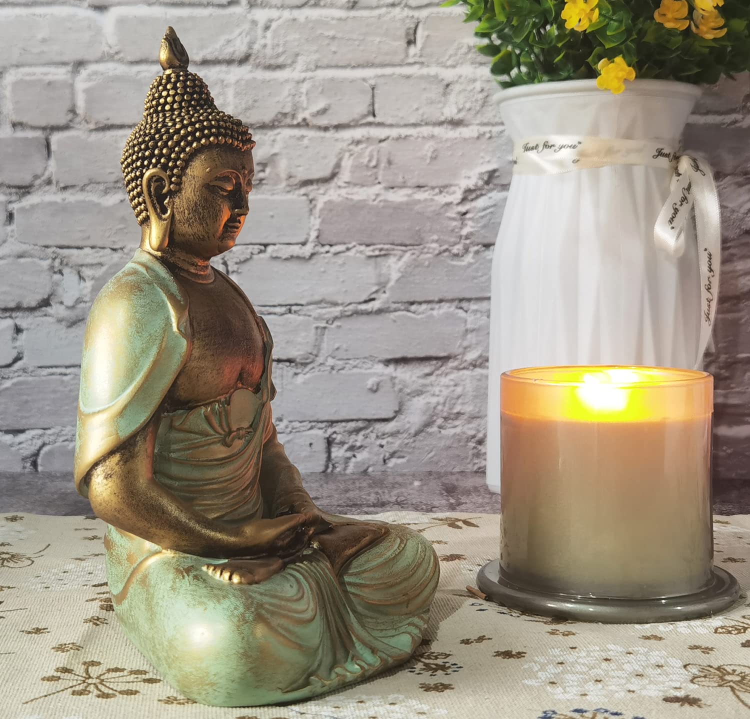 Angel Shine meditation decor statue pairs with plants and candles for relaxation.