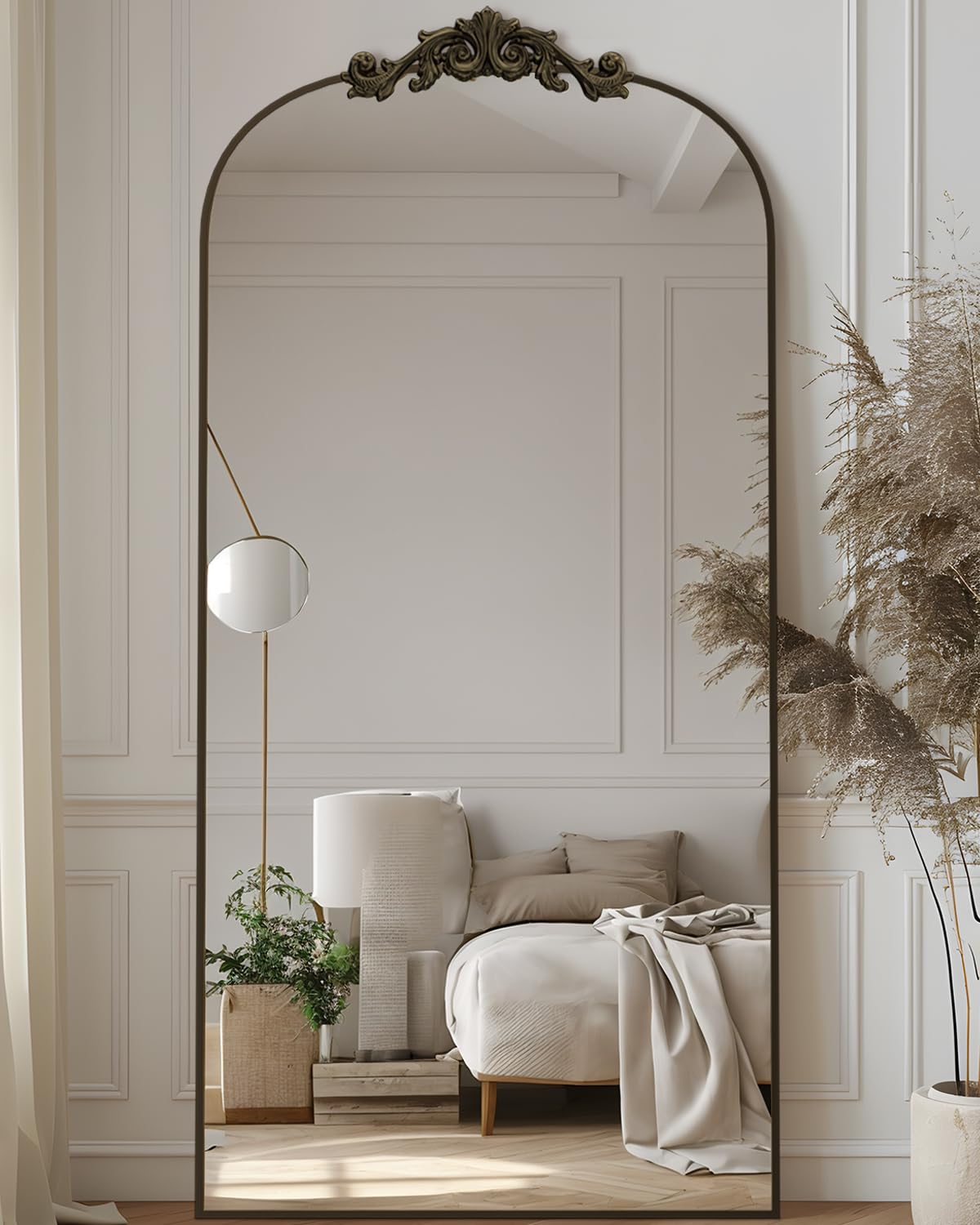 Antok arched mirror with bronze carved frame for full-body outfit checks.