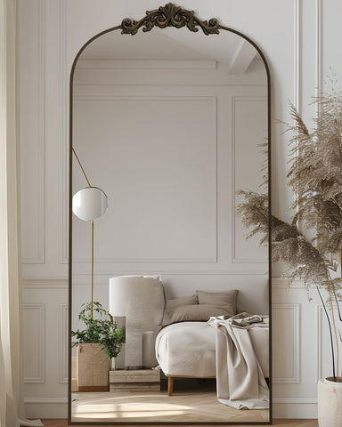 Antok arched mirror with bronze carved frame for full-body outfit checks.