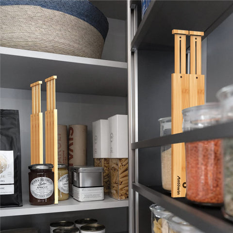 ANTOWIN dividers organizing towels, belts, and apparel with expandable length.