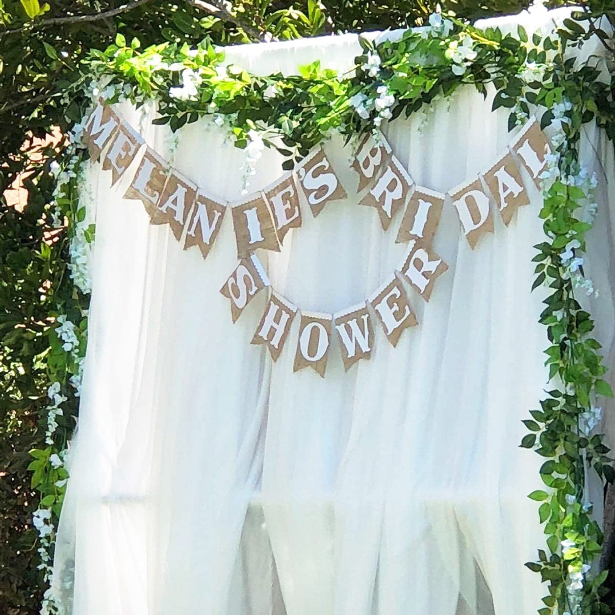 Outdoor ceremony setup with Antspirit Wisteria garland backdrop.