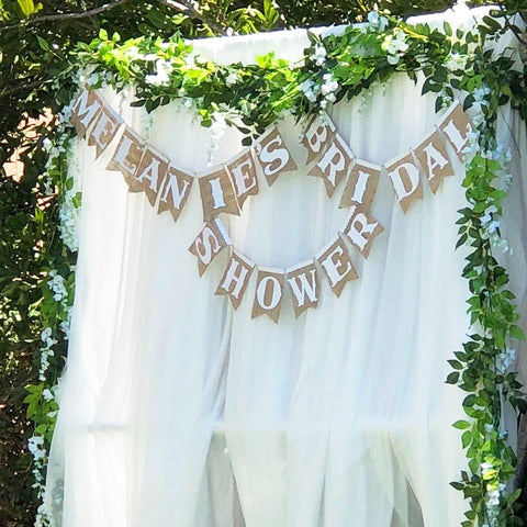 Outdoor ceremony setup with Antspirit Wisteria garland backdrop.