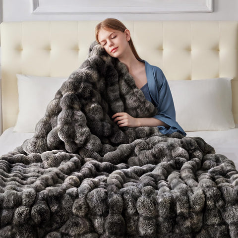 Anysay faux fur blanket shown on bed for cozy evenings.