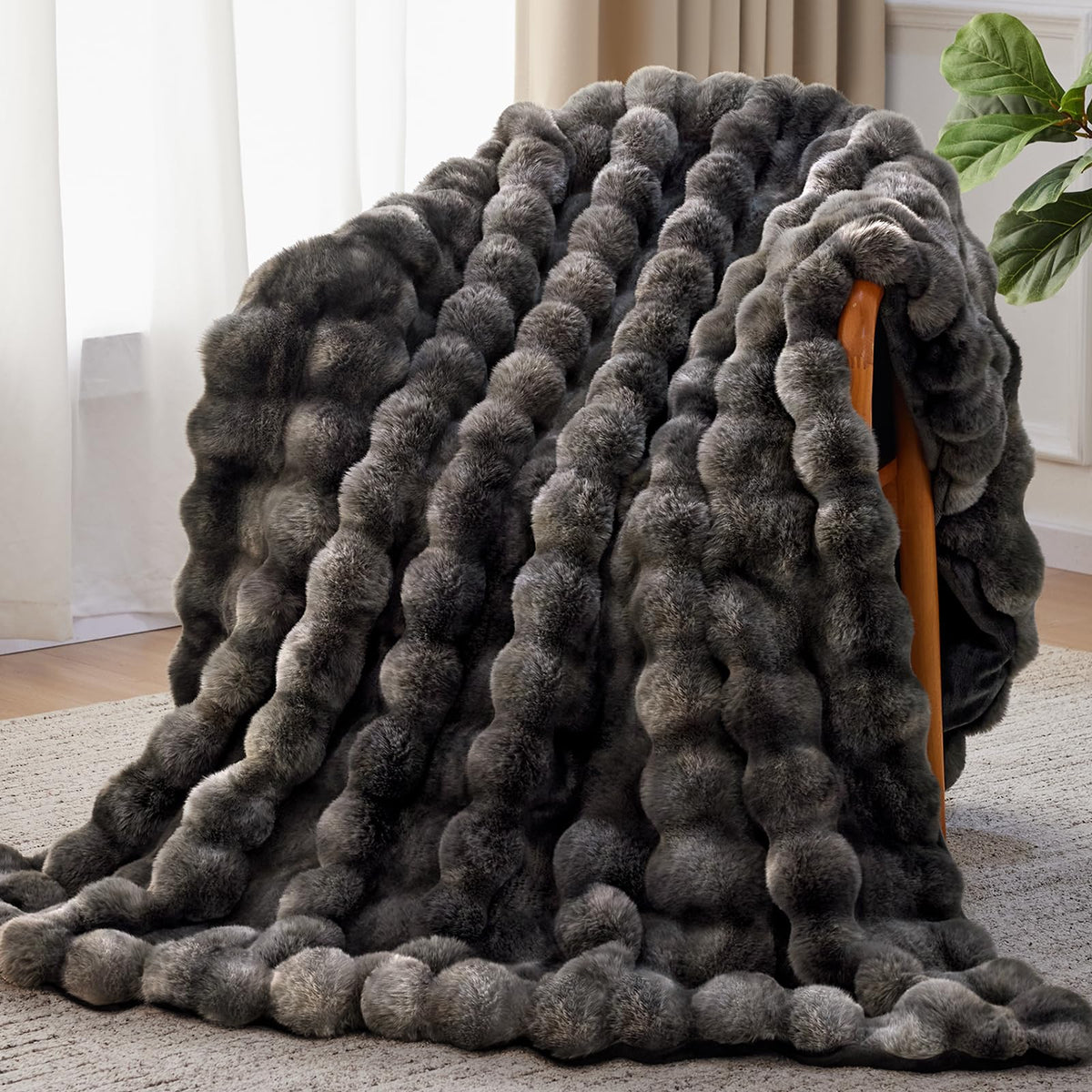 Anysay faux fur throw blanket draped over a sofa for cozy living room warmth.