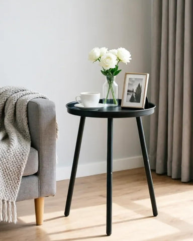 AOJEZOR round-top side table with three legs, matte black finish, ideal for tight spaces.