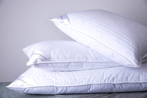 Bedroom scene featuring ArcticNorthDown pillow suitable for back, side, and stomach sleepers.