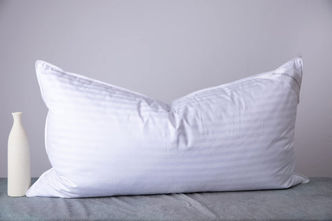 ArcticNorthDown king size pillow with striped white cotton cover for all sleeping positions.