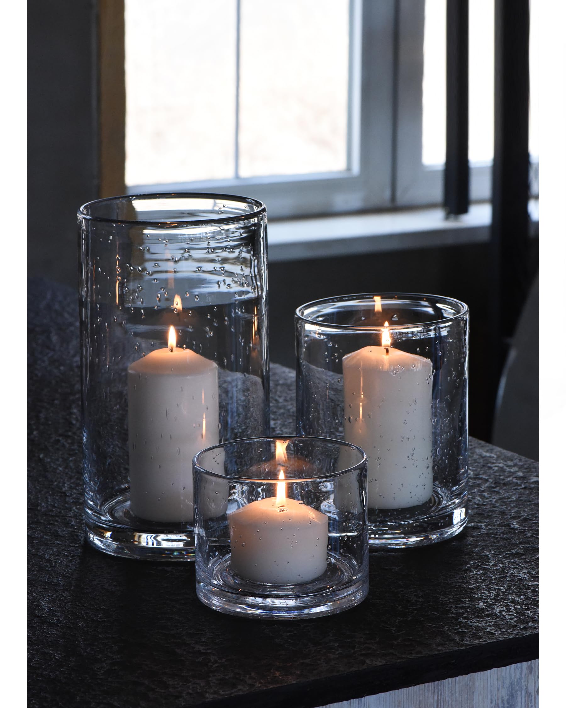 ARIAMOTION hurricane candle holders in hand blown glass with seeded bubbles adding refined dining ambience.