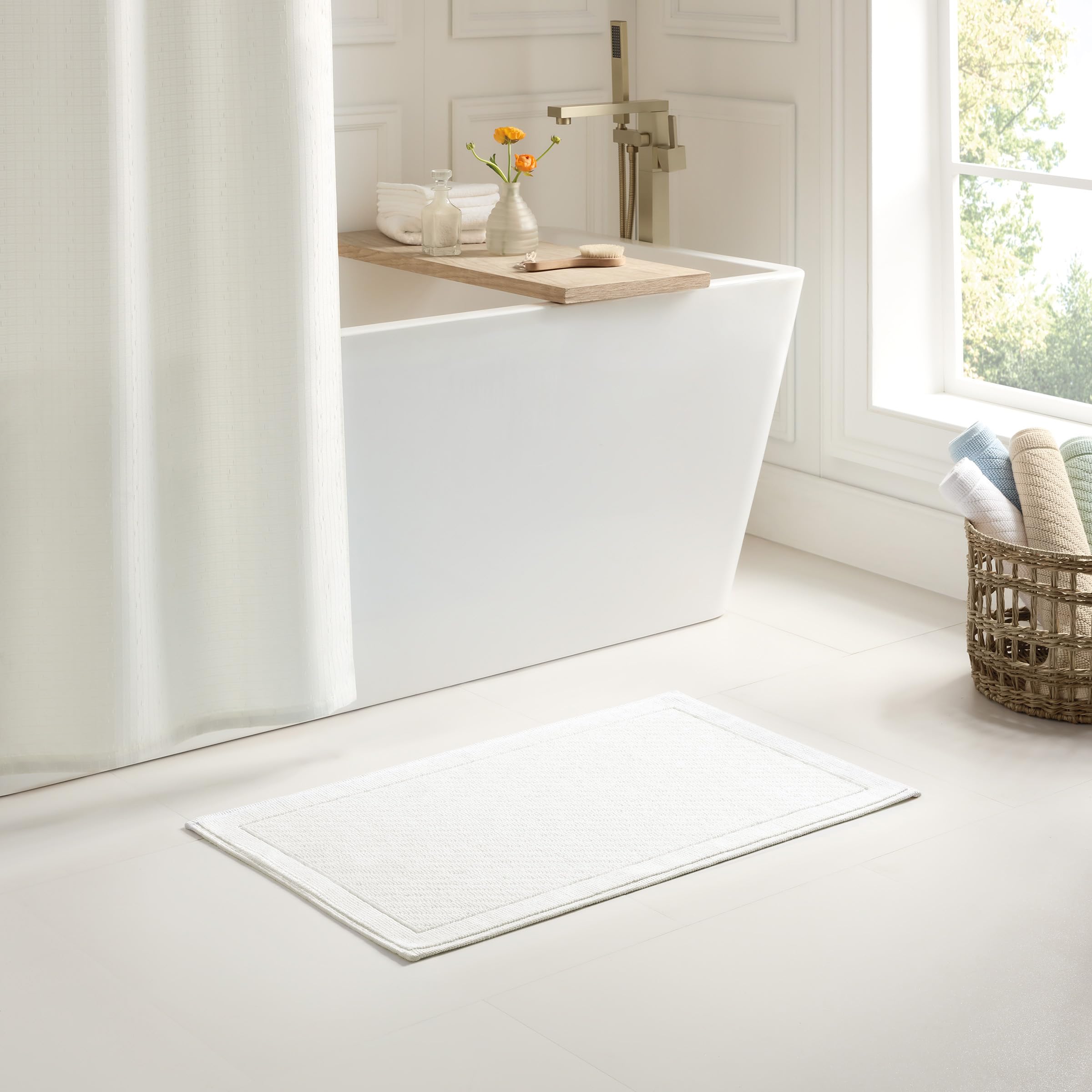 Arkwright 24x36 white bath rug complements any decor while plush and comfortable.