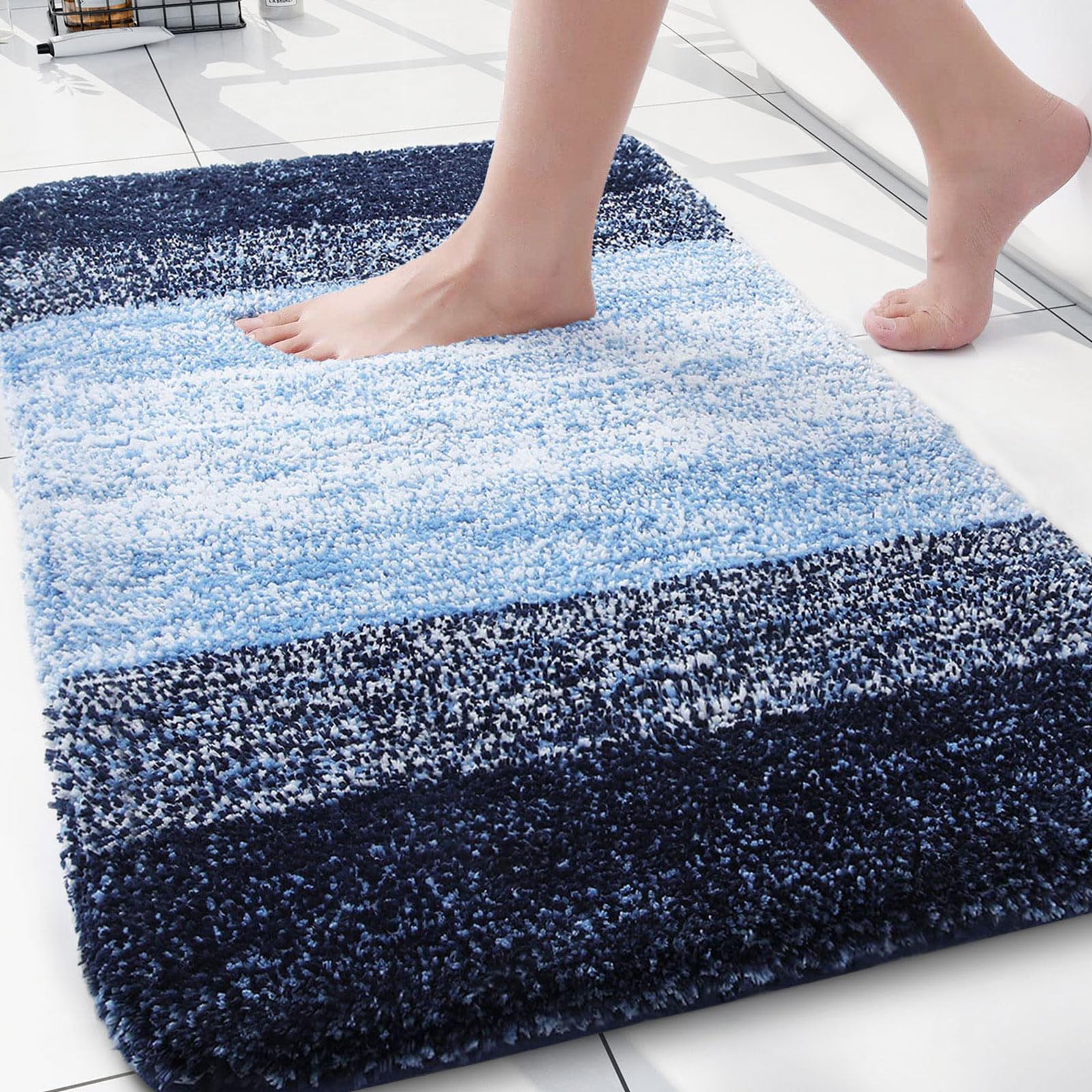 Arotive bath rug with soft shaggy blue fibers for cozy feet after showers.