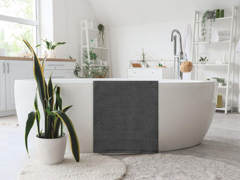 ASTILTEX charcoal-grey towel shown for after-shower drying with plush softness.