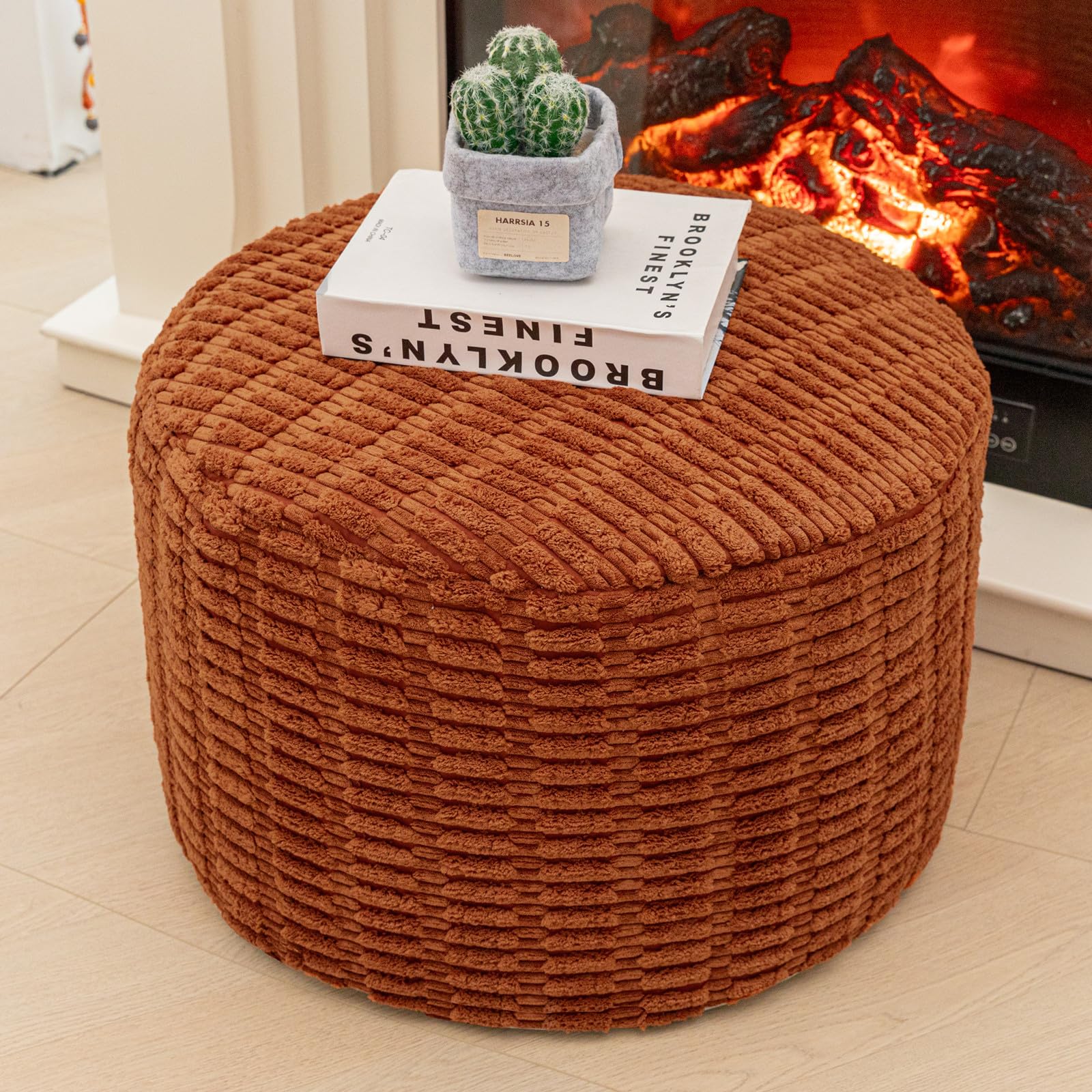Asuprui pouf ottoman orange round with soft-touch surface for feet.
