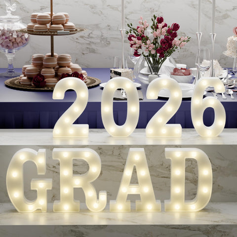 Atronor Grad 2026 LED letters on a table for graduation decor.