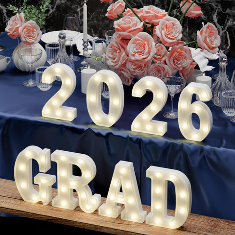 Atronor Grad 2026 LED letters brightened on a table display.