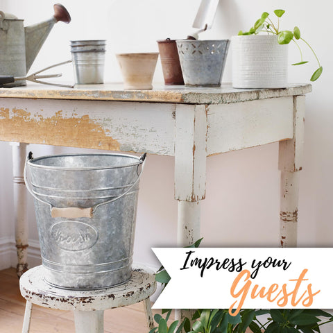 Autumn Alley toilet brush holder matches trash can with galvanized accents for cohesive decor.