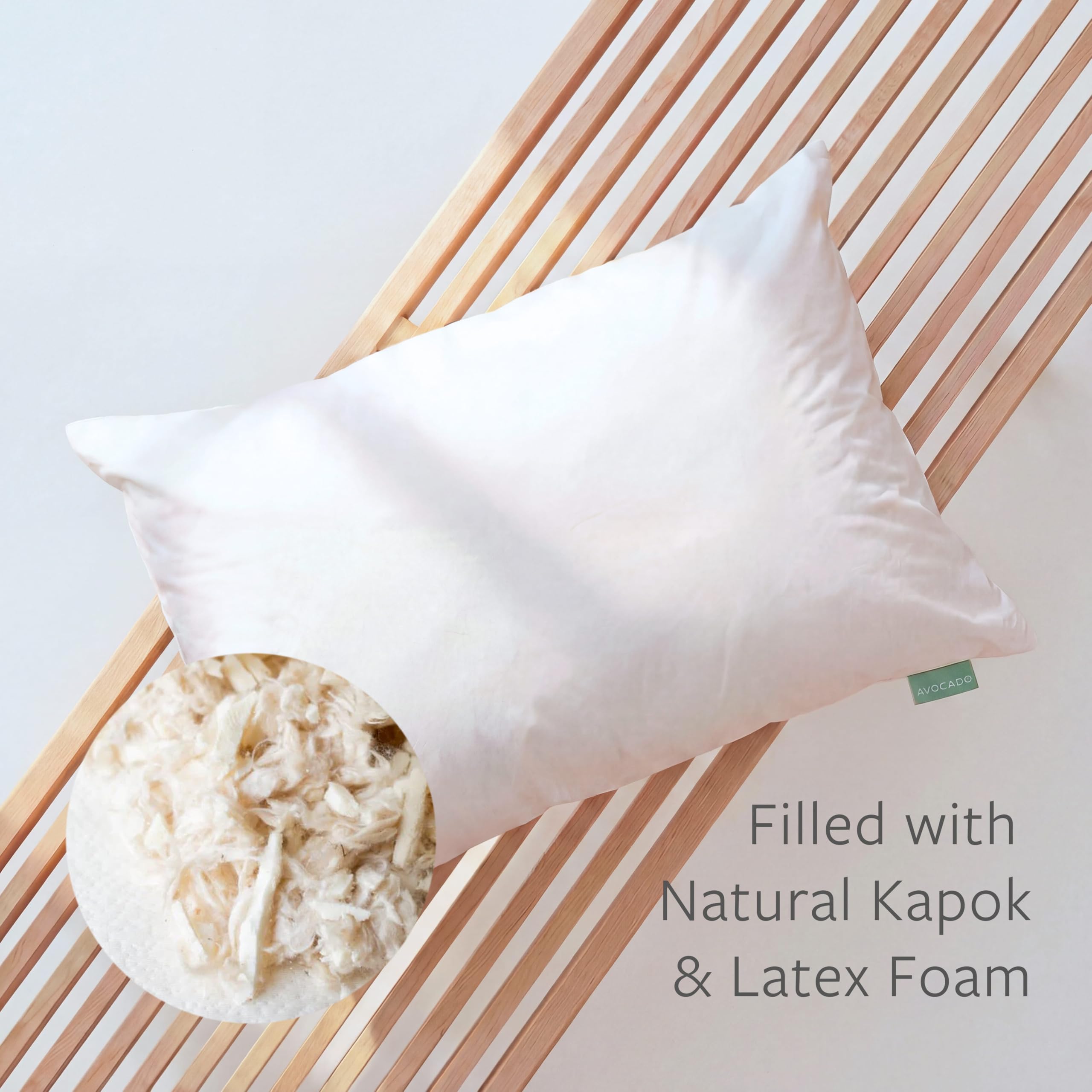 Queen-size Avocado Organic Cotton Pillow resting on a neatly made bed.