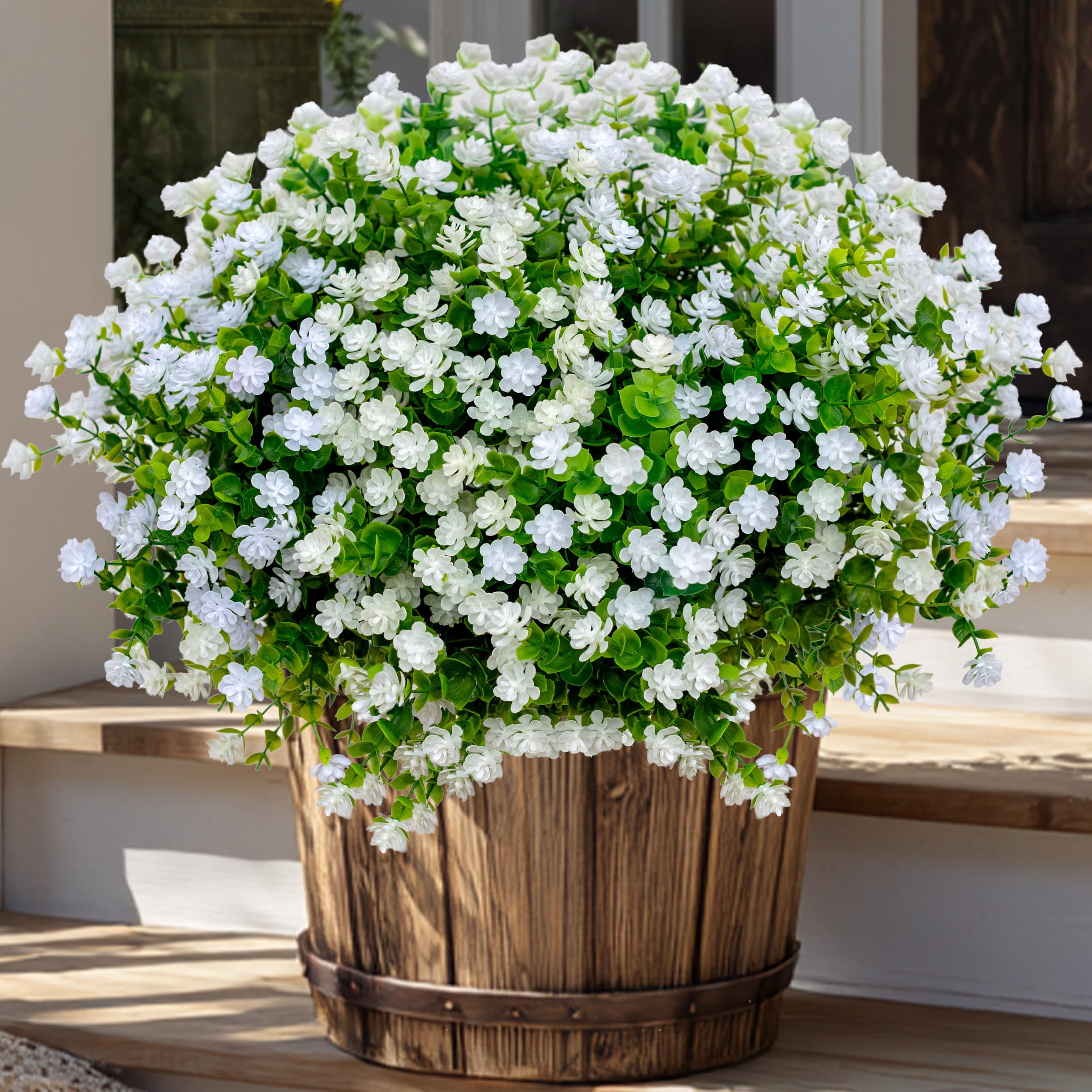 AXYLEX faux plants create inviting outdoor seating areas without maintenance.