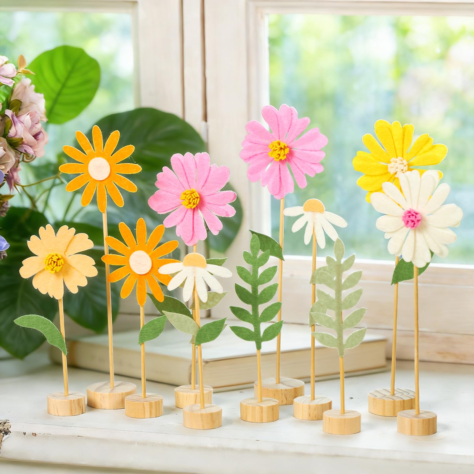 Balun Admhail baby shower decor featuring daisies on wooden bases.
