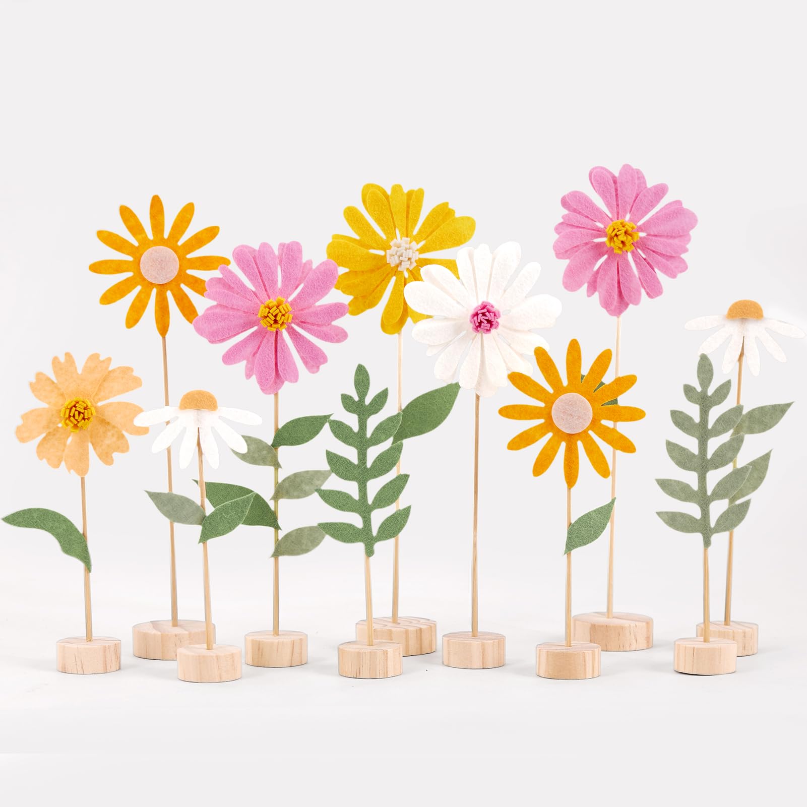 Balun Admhail daisy centerpieces with wooden bases brighten wedding reception tables.