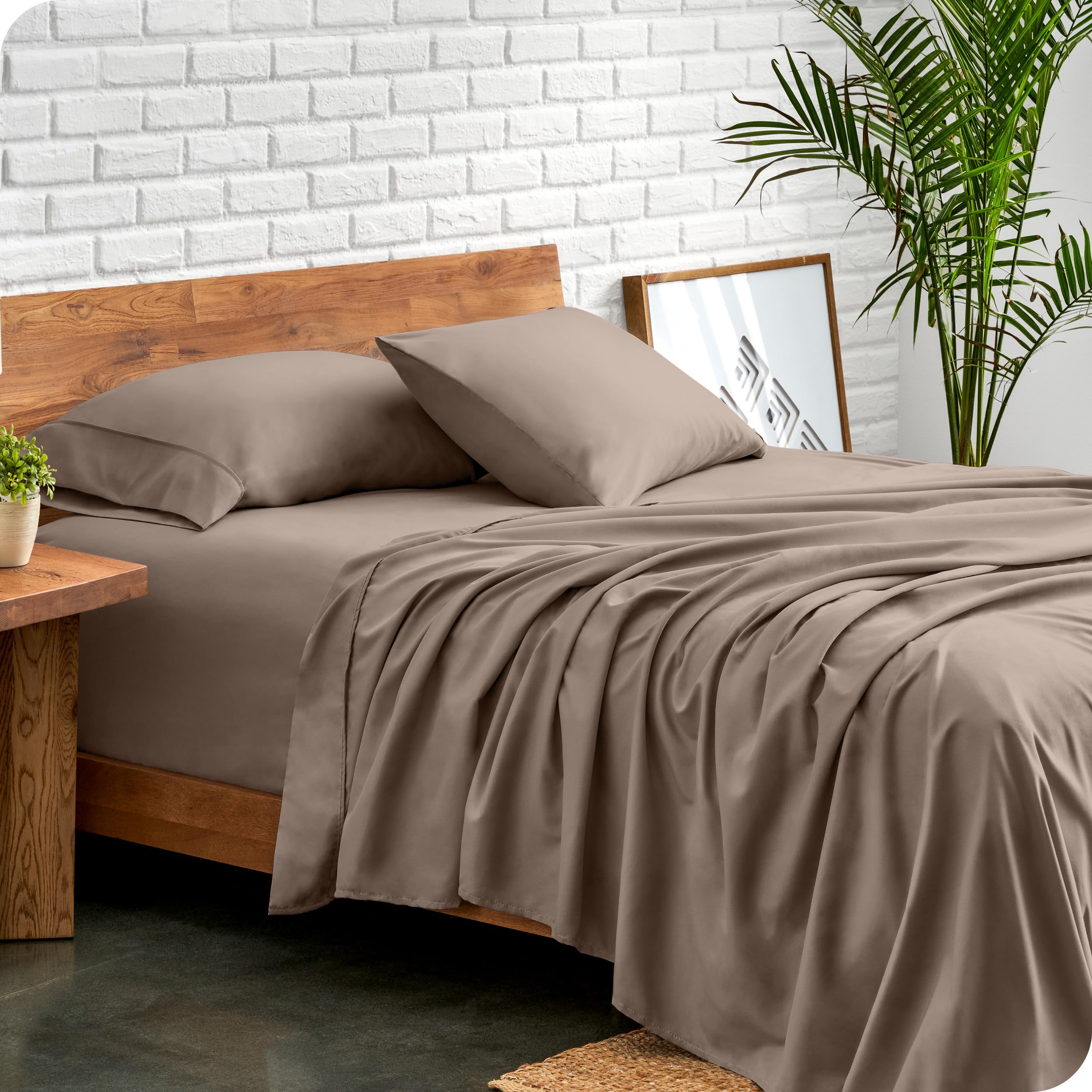 Bare Home king sheet set flat sheet laid out, highlighting generous sizing for easy bedding.