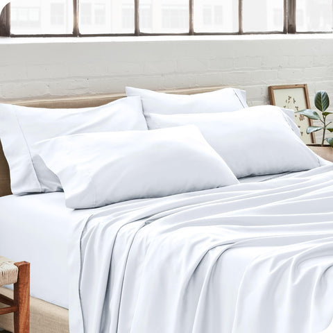 Bare Home four-pack pillowcases on bed, clean white style ready for nightly use.