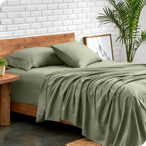 Bare Home queen sheet set sage on bed demonstrates color and deep pocket fit
